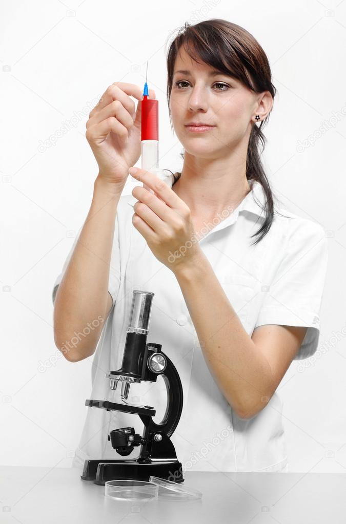 Female scientist with microscope.