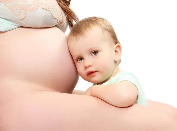 Kleines Mädchen und ihre schwangere Mutter. Glückliches Familienkonzept. — Stockfoto