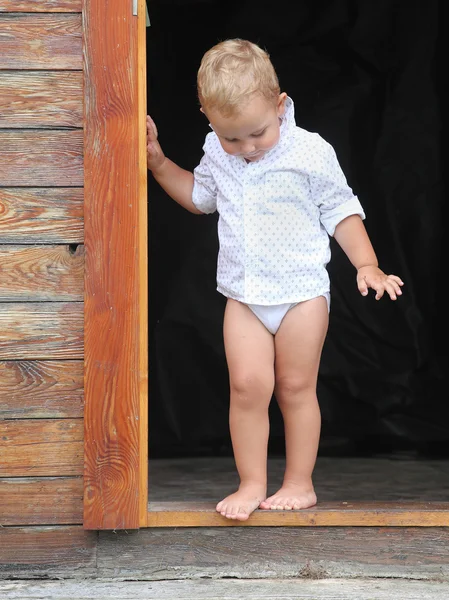 Boy standing in doorway — Stock Photo, Image