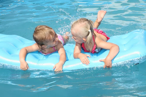 Children swimming in air mattress — Stock Photo, Image
