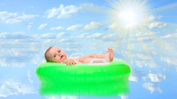 Happy baby playing in rubber dinghy. — Stock Photo, Image