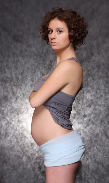 Beautiful pregnant woman on black background. Studio shot. — Stock Photo, Image