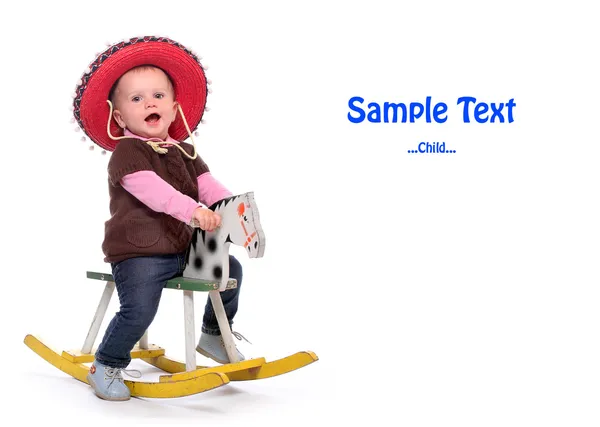 Happy child on a rocking horse with space for your text. — Stock Photo, Image