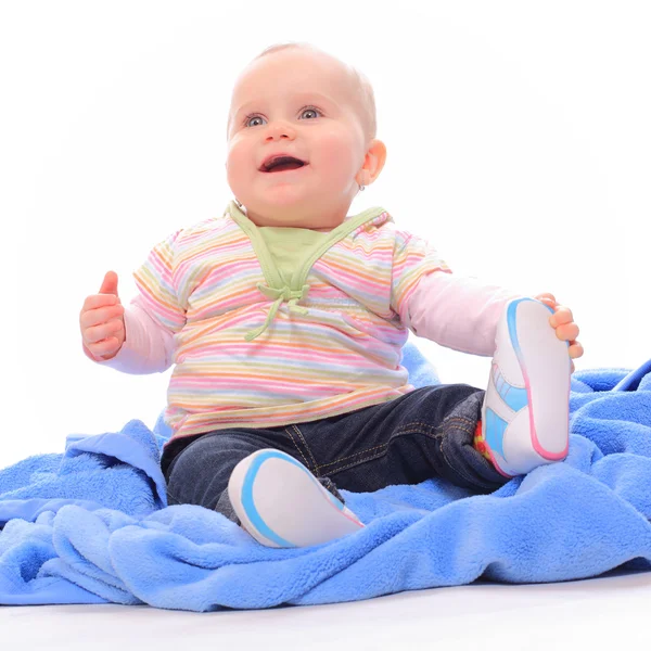 Mavi havlu üzerinde oturan sevimli bebek. — Stok fotoğraf