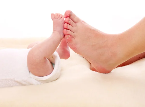 Baby feet and mother's feet. Little and big. Stock Photo by ©vladvitek