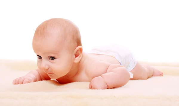 Carino bambino su una coperta peluche . — Foto Stock