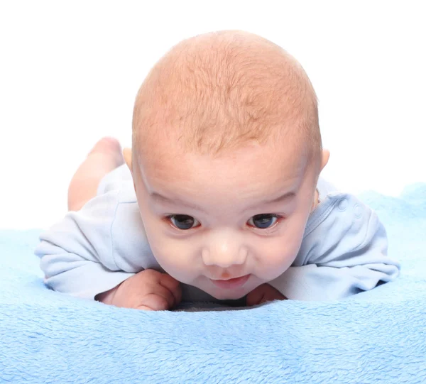 Funny picture of a cute baby on a blue towel. — Stock Photo, Image