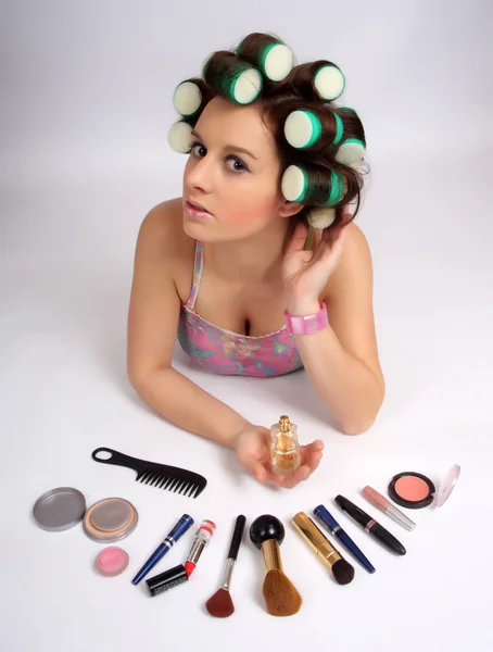 Young beautiful girl is having hair curlers on her head — Stock Photo, Image