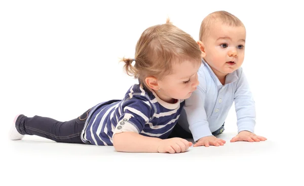 Playing children. An girl with her little brother on a white background. Stock Image