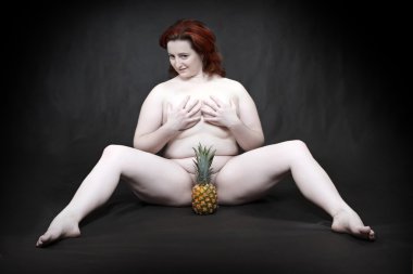 ananas ile oturan çıplak kadın