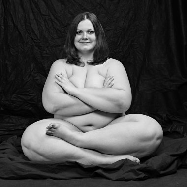 Happy overweight woman in yoga position