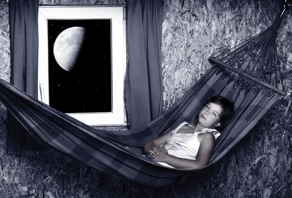 Resting young girl on a hammock in living room - nightshot — Stock Photo, Image