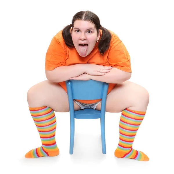 Crazy teenager on a blue chair. Behavioral disturbance in the pubescence. — Stock Photo, Image