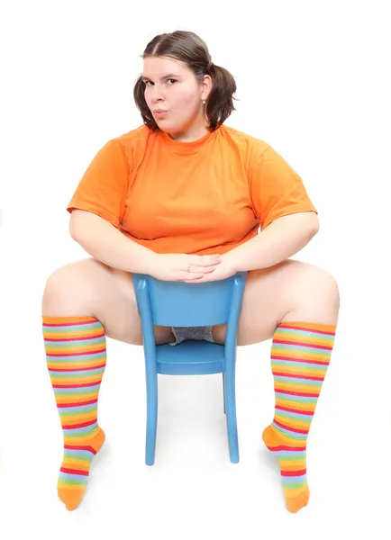 Crazy teenager on a blue chair. Behavioral disturbance in the pubescence. — Stock Photo, Image