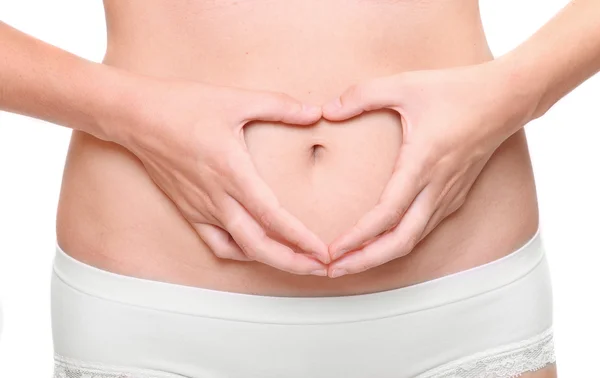 Woman doing hearth on belly. — Stock Photo, Image