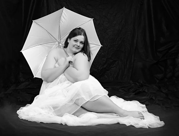 Retro style picture of a overweight woman posing on a black background. — Stock Photo, Image