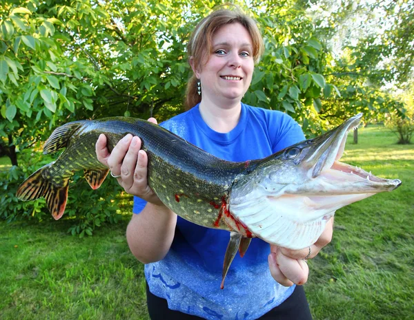 Mulher pescador bem sucedido com um grande Northern Pike . — Fotografia de Stock
