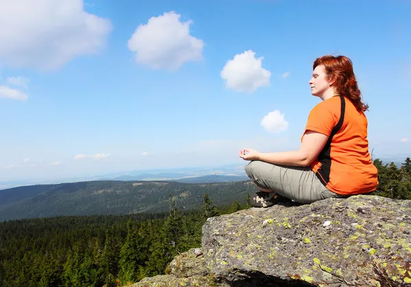 Jovem mulher meditando em um pico alto . — Fotografia de Stock