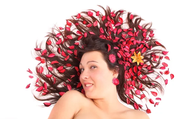 Beautiful young woman with dried herbs on her long hair. — Stock Photo, Image