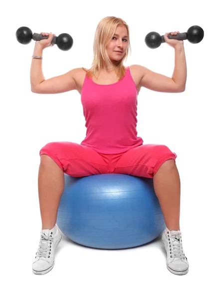 Sitting  Fitness woman on ball with dumbbells Stock Picture
