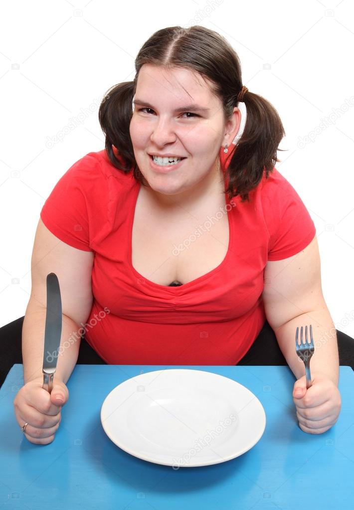 Hungry woman with empty plate