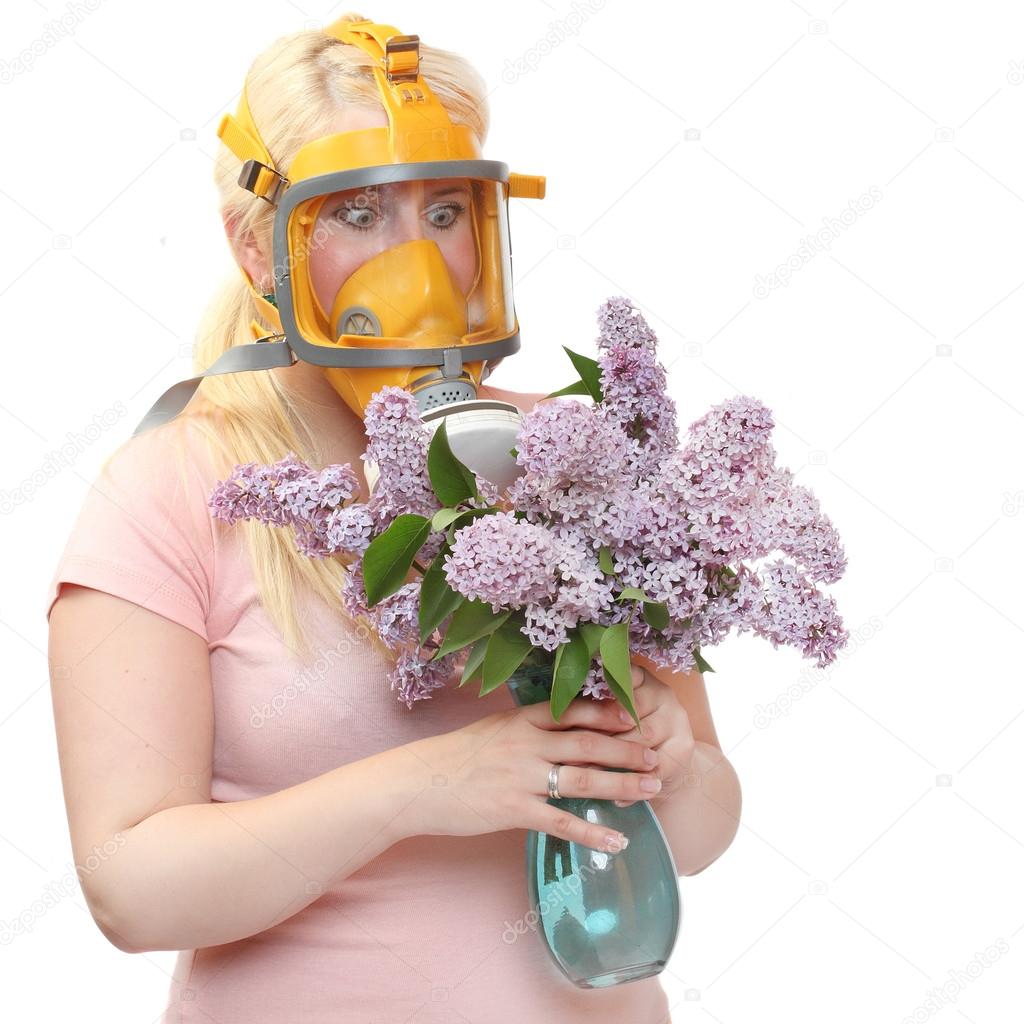 Woman with flowers in protection mask