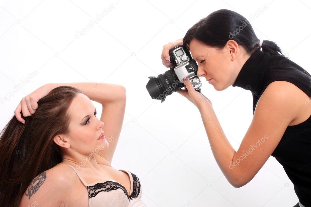 Professional photographer and a model working in a studio.