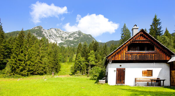Wooden house in Alps landscape
