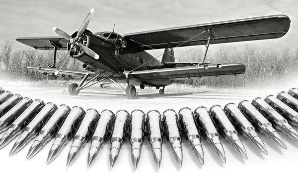 Silver chain of powerful cartridges and plane — Stock Photo, Image