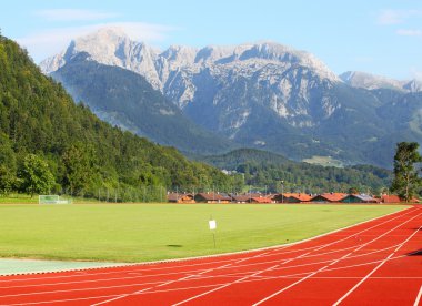 Running track under Berchtesgaden Alps. clipart