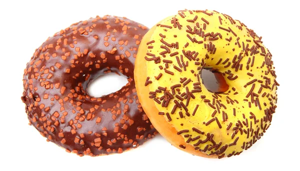 Två glasade donut med kakao och vanilj strössel — Stockfoto