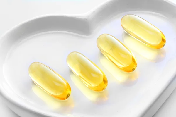 The Omega-3 pills on a white plate — Stock Photo, Image