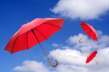 Three red umbrellas flying clipart