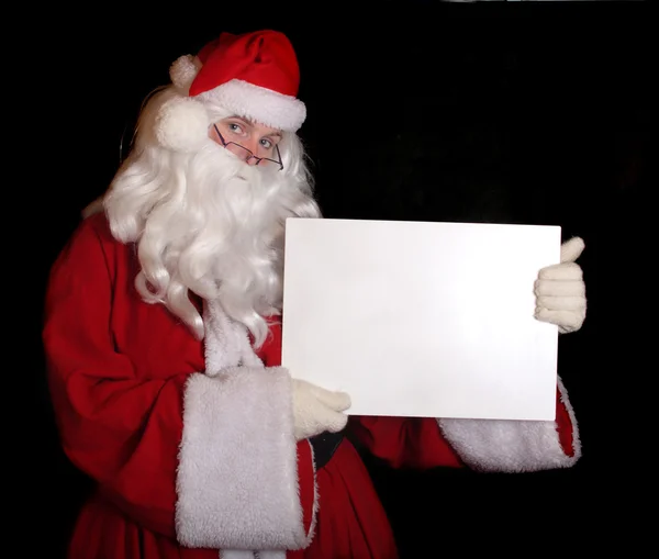 Papai Noel mostrando papel — Fotografia de Stock