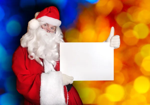 Santa che mostra carta e pollice in su — Foto Stock