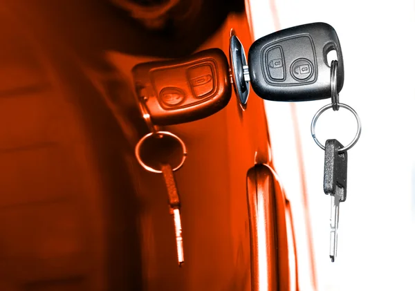 Key at orange car doors — Stock Photo, Image