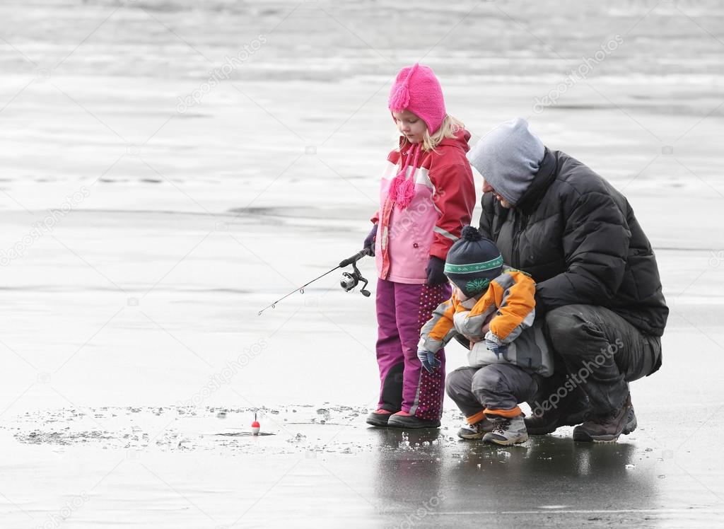 Father teaching children fishing
