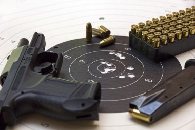 Gun and ammunition over bullseye score clipart