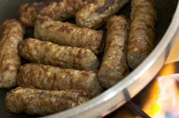 Cooking sausages in a pan — Stock Photo, Image