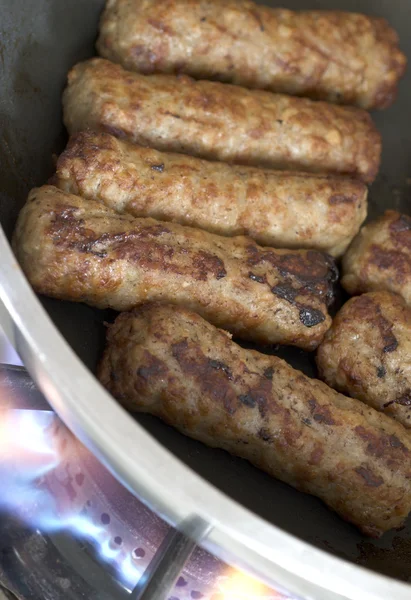 Cooking sausages in a pan — Stock Photo, Image