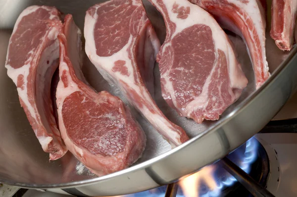 Rib lamb chops in frying pan cooking — Stock Photo, Image