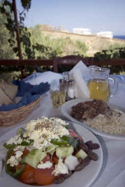 Greek taverna lunch over sea view clipart
