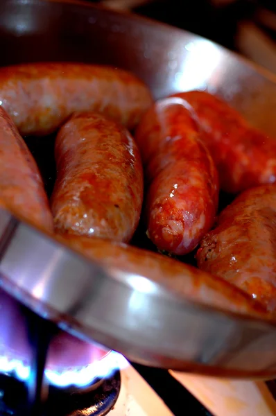 Italian sausage frying — Stock Photo, Image