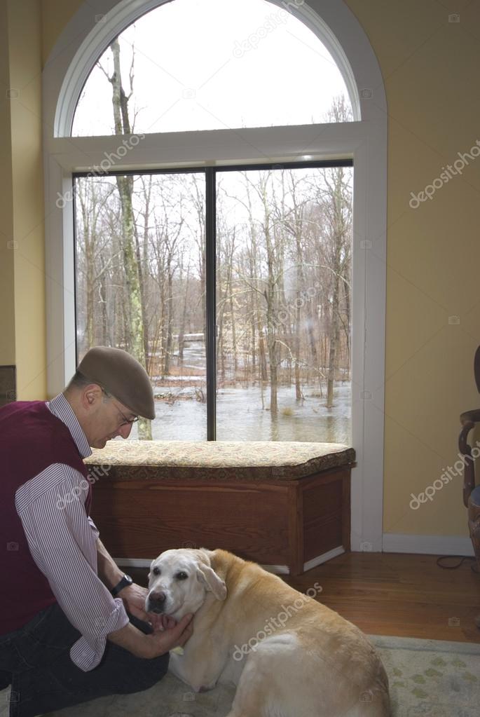 man and his dog in the living room flood in backyard