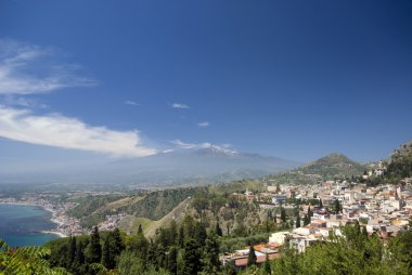 panoramic view of taormina and mt. etna clipart