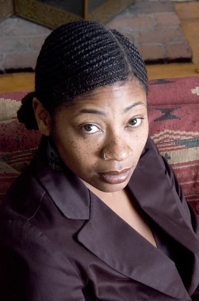 Beautiful black woman on sofa — Stock Photo, Image