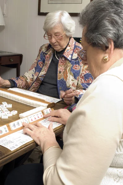 Senior woman at the game table — Stock Photo, Image