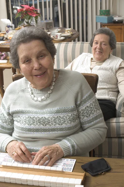 Senior woman at the game table — Stock Photo, Image