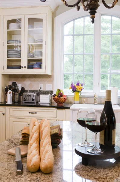 Kitchen island with wine baguettes — Stock Photo, Image