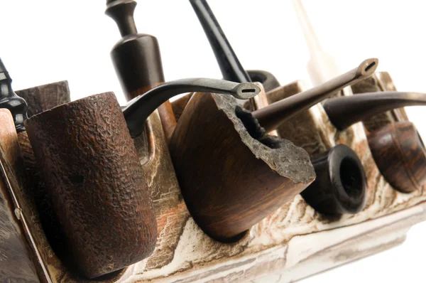 Pipe collection on modern pipe rack — Stock Photo, Image